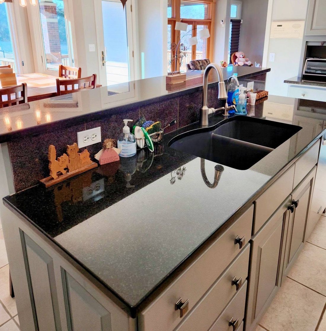 Kitchen island and granite counters cleaned by Breeze Cleaning